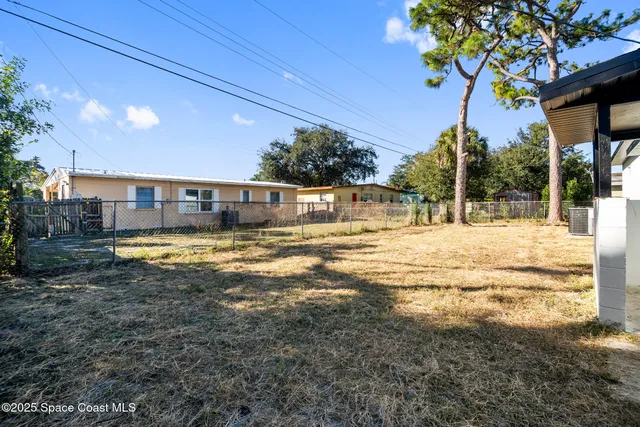 a swimming pool with outdoor seating and yard