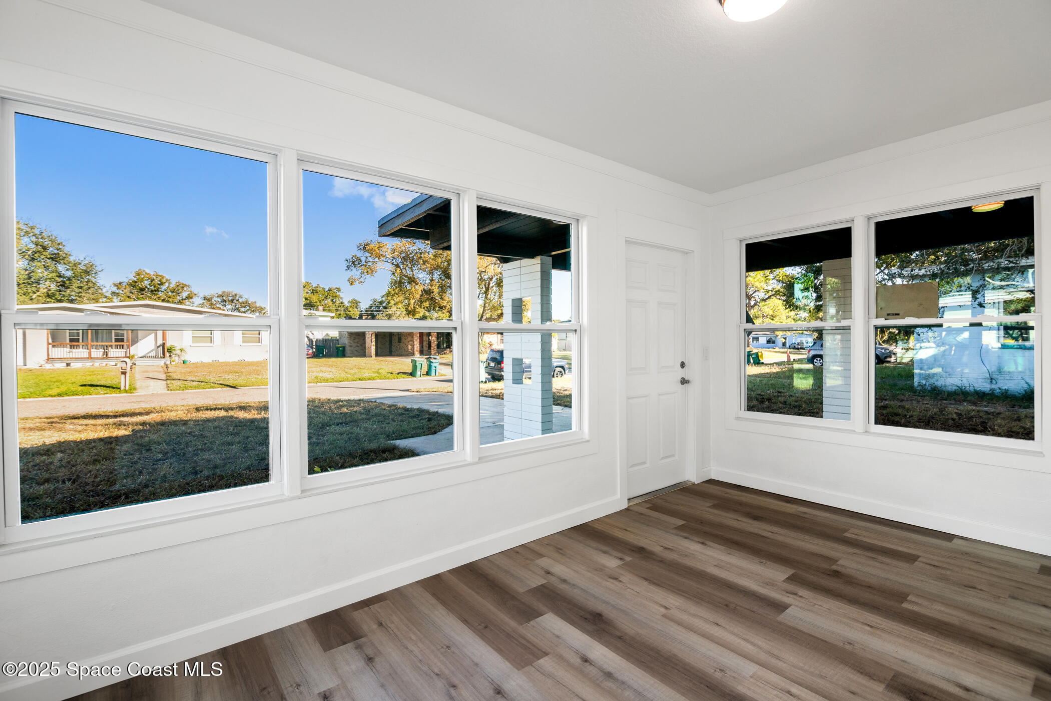 1107 Abington Street Cocoa, FL 32922 - Photo 5 of 20 a view of an entryway with wooden floor and a floor to ceiling window