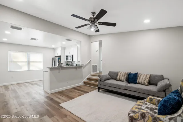 a living room with furniture and kitchen view