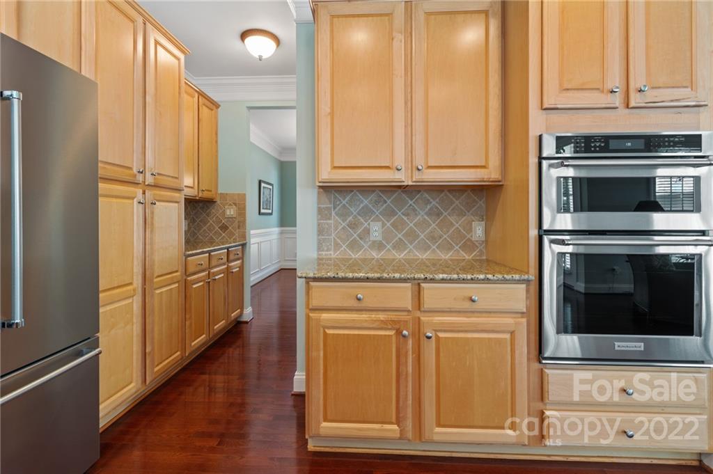 389 Third Baxter Street Fort Mill, SC 29708 - Photo 13 of 48 a kitchen with granite countertop white cabinets and stainless steel appliances