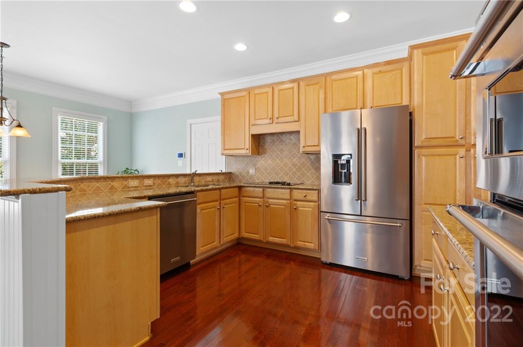 389 Third Baxter Street Fort Mill, SC 29708 - Photo 15 of 48 a kitchen with stainless steel appliances granite countertop a refrigerator stove and wooden floor