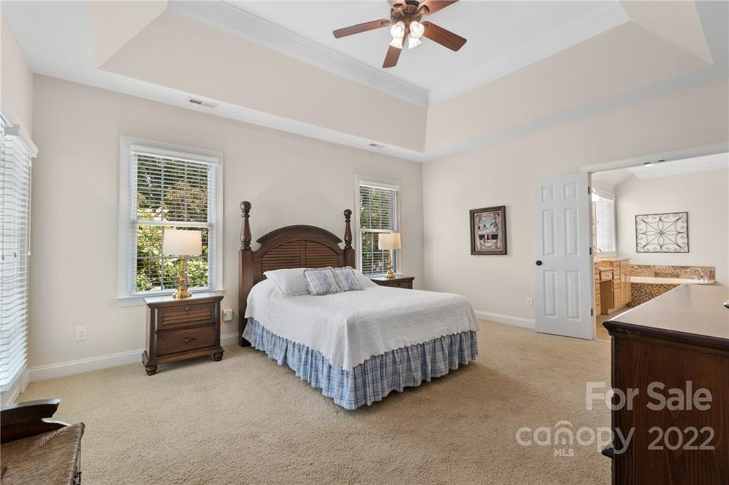 389 Third Baxter Street Fort Mill, SC 29708 - Photo 28 of 48 a bedroom with a bed and a chandelier