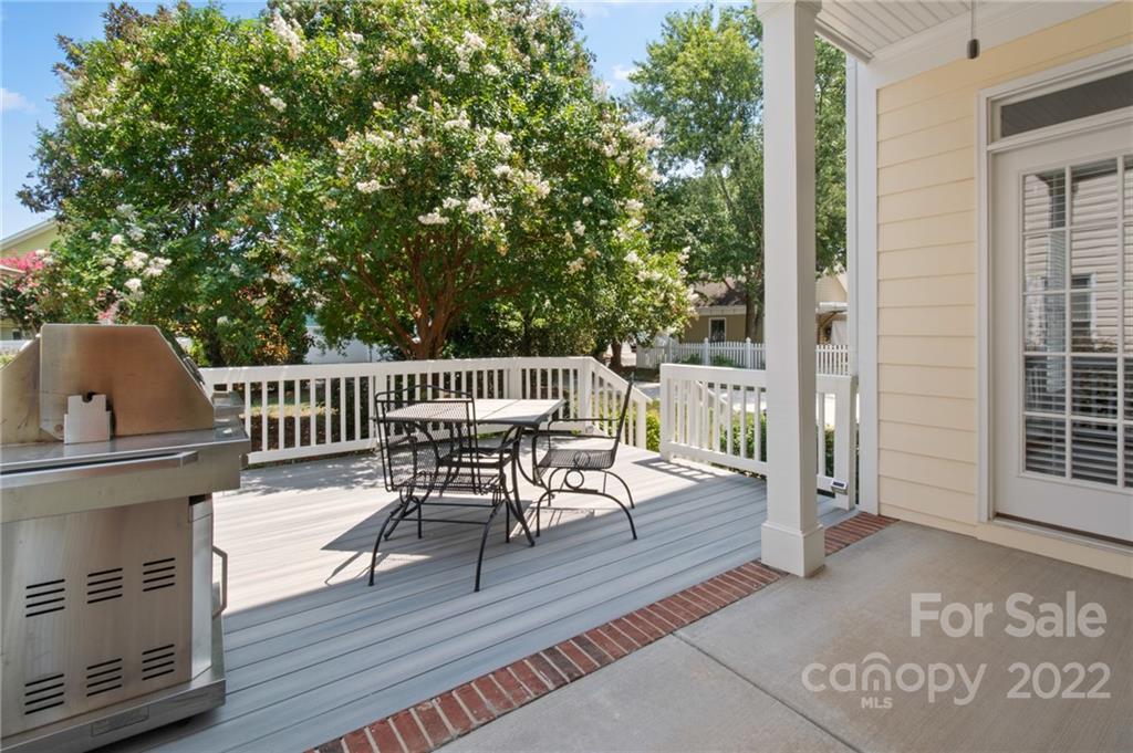 389 Third Baxter Street Fort Mill, SC 29708 - Photo 42 of 48 a view of a patio with table and chairs with wooden floor and fence