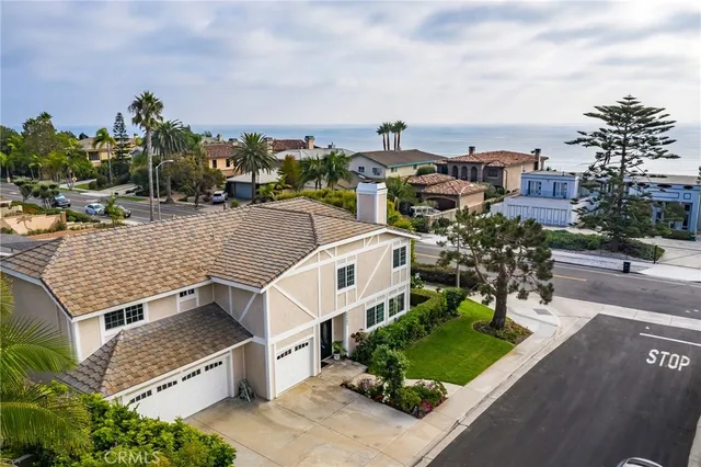 an aerial view of a house with a yard and large trees