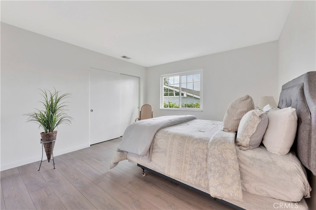 27282 Via Bella Dana Point, CA 92624 - Photo 26 of 50 a bedroom with bed and a potted plant