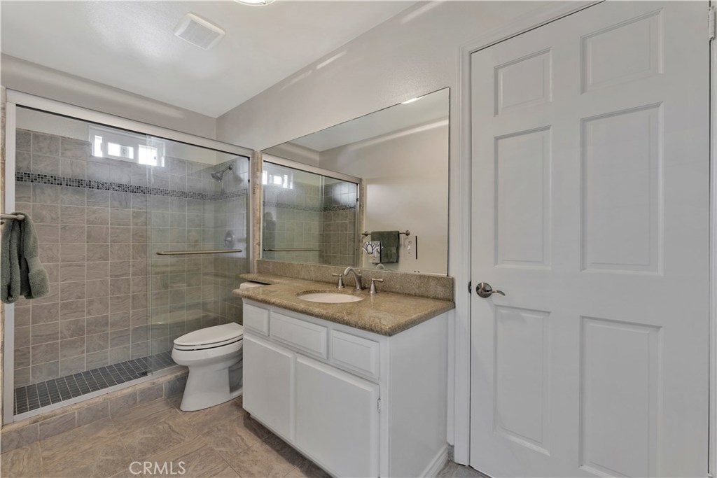 27282 Via Bella Dana Point, CA 92624 - Photo 29 of 50 a bathroom with a granite countertop sink a toilet and shower
