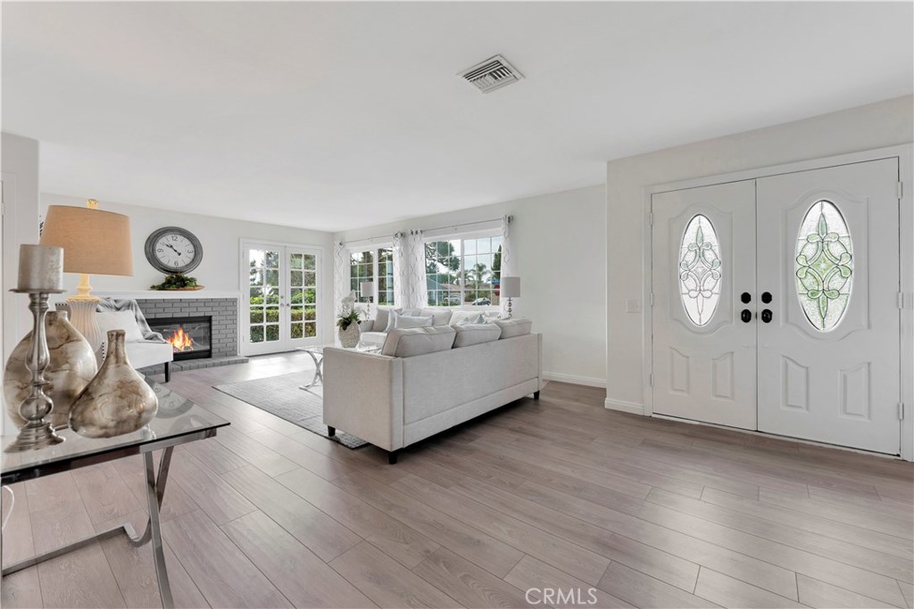 27282 Via Bella Dana Point, CA 92624 - Photo 30 of 50 a living room with fireplace furniture and a wooden floor