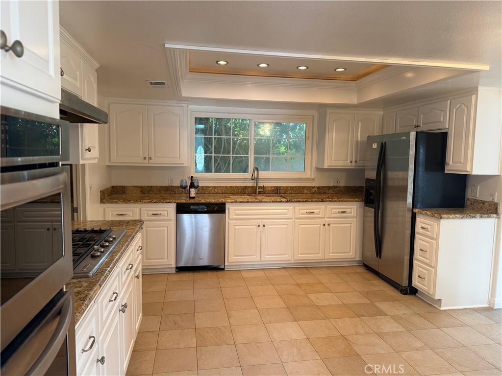 27282 Via Bella Dana Point, CA 92624 - Photo 34 of 50 a kitchen with a stove a sink and a refrigerator