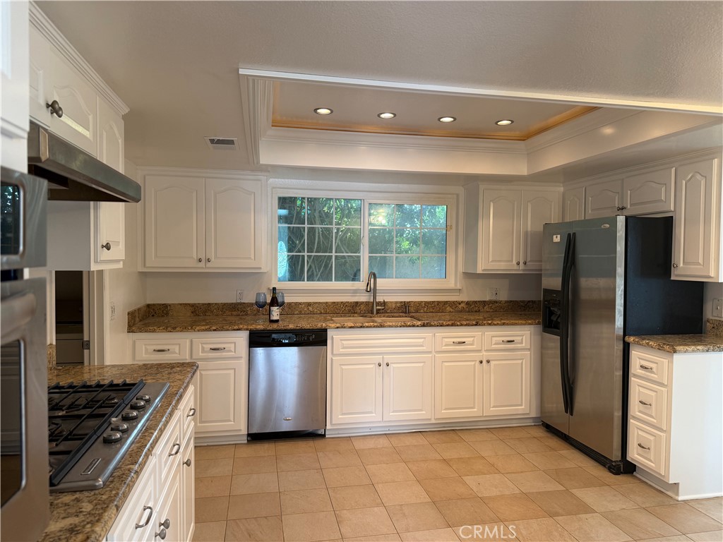 27282 Via Bella Dana Point, CA 92624 - Photo 36 of 50 a kitchen with stainless steel appliances a sink stove refrigerator and cabinets