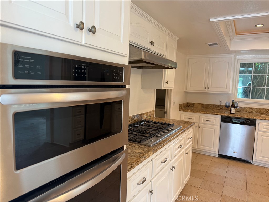 27282 Via Bella Dana Point, CA 92624 - Photo 37 of 50 a kitchen with stainless steel appliances granite countertop a stove and a microwave