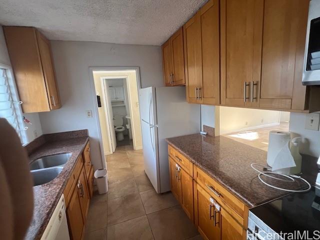 1447 Kewalo Street, Unit 207 Honolulu, HI 96822 - Photo 2 of 4 a kitchen with a sink stove and cabinets