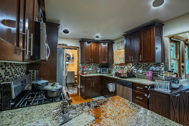 a dining room with furniture a chandelier and wooden floor