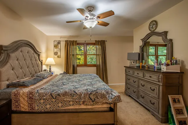 a bathroom with a granite countertop toilet a sink and a mirror