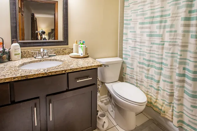 a bed sitting in a bedroom and chair