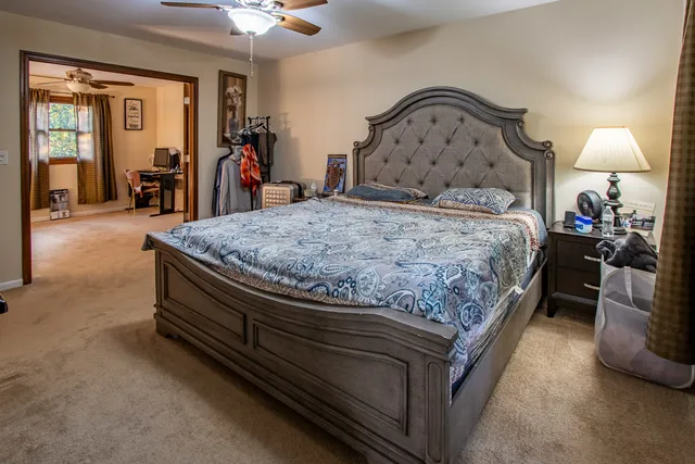 a bedroom with a bed and a chandelier