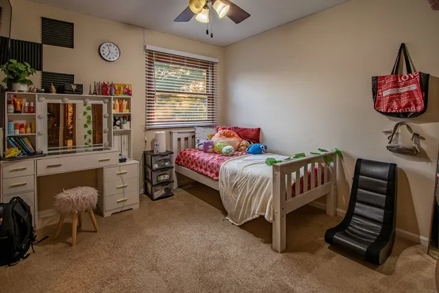a bedroom with furniture and a flat screen tv