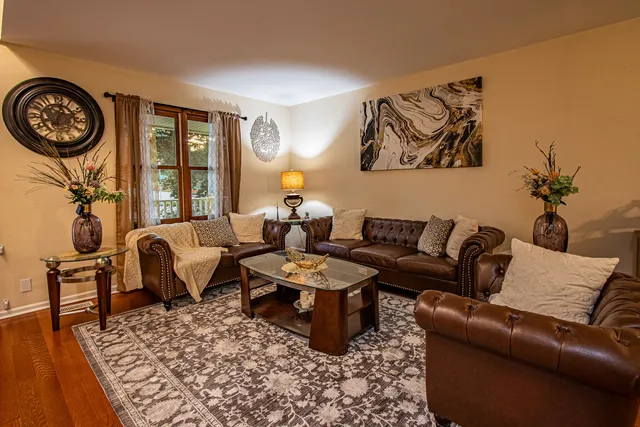 a living room with furniture and a clock