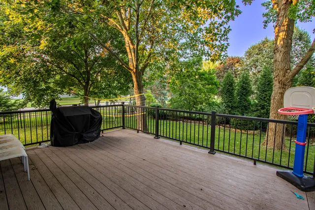a view of a deck with table and chairs and wooden floor