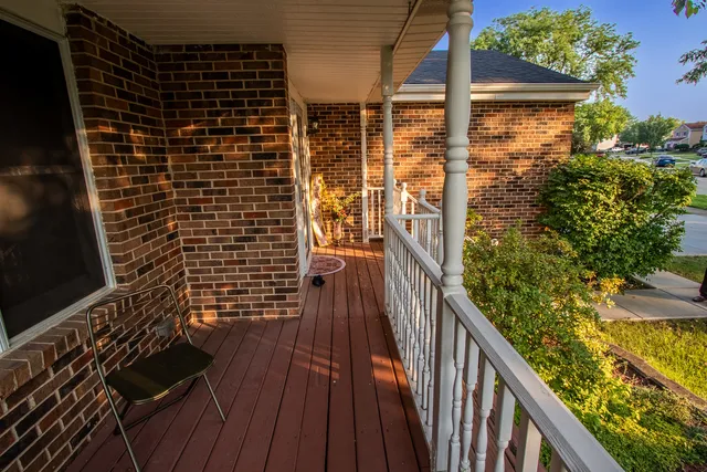 a view of a hallway with wooden floor and furniture