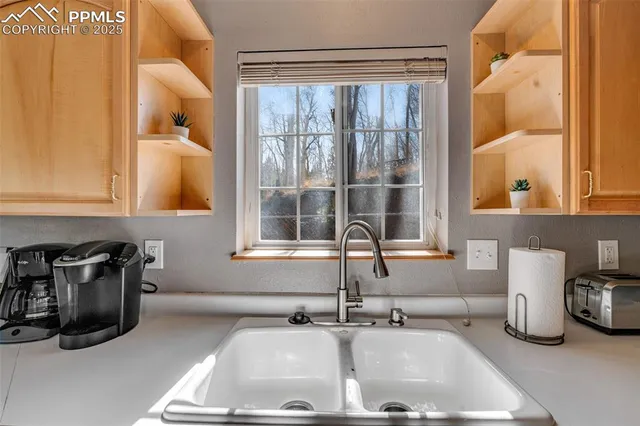 a kitchen with sink and window