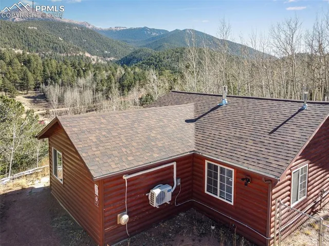 a view of a house with a yard covered in snow