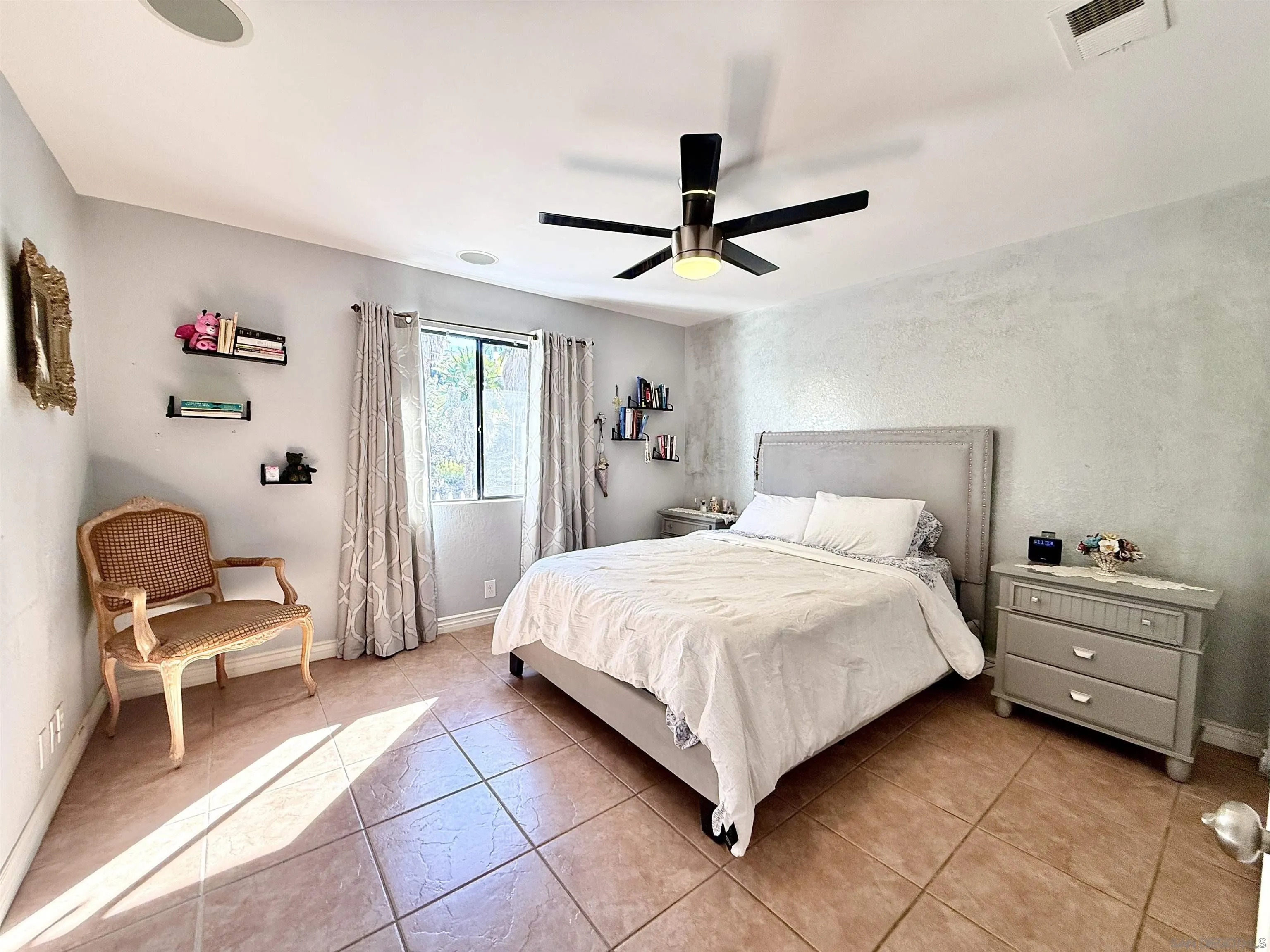 1423 Vista Grande Road El Cajon, CA 92019 - Photo 14 of 25 a bedroom with a bed and a chair