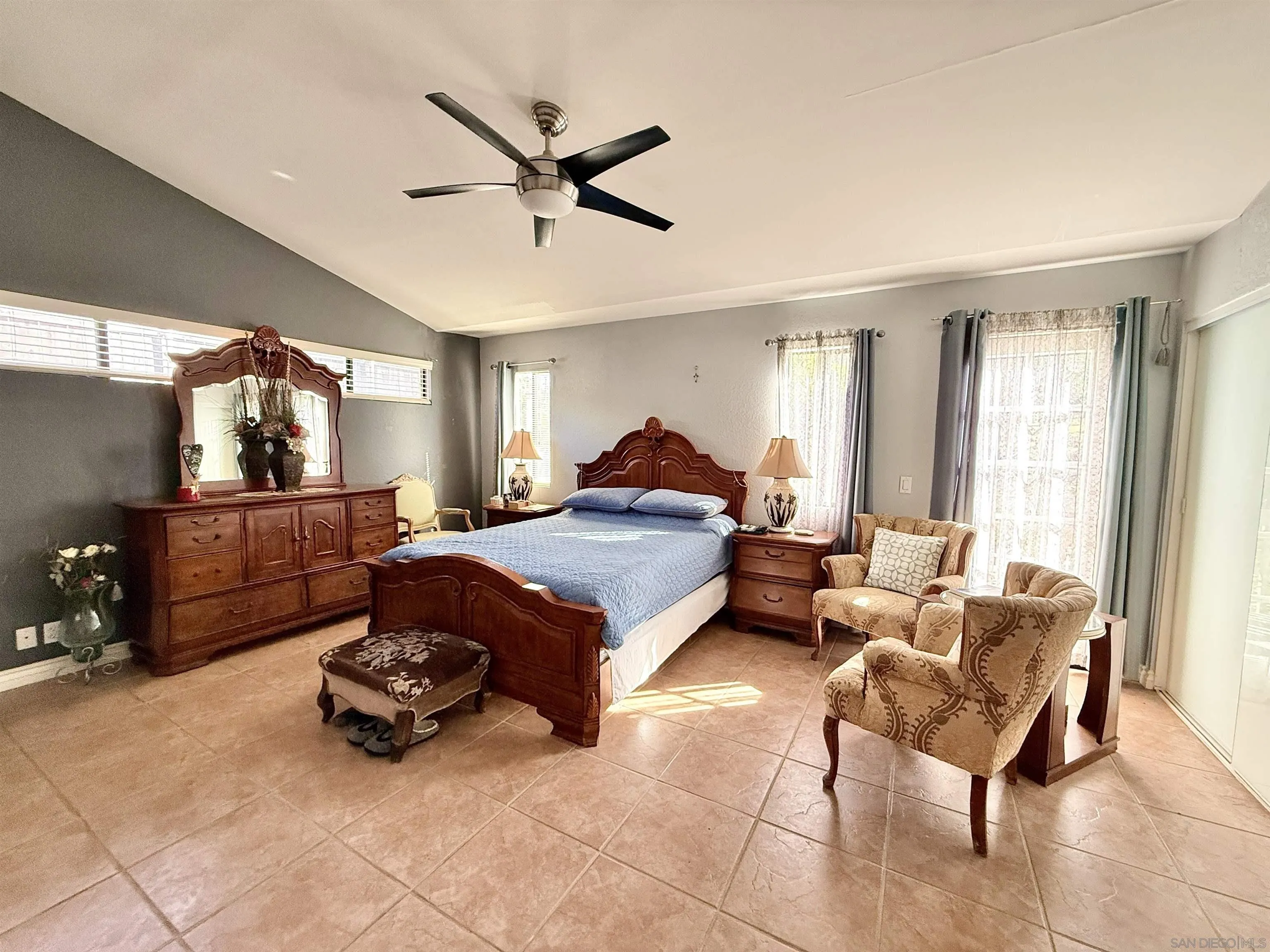 1423 Vista Grande Road El Cajon, CA 92019 - Photo 17 of 25 a spacious bedroom with a bed and a chandelier