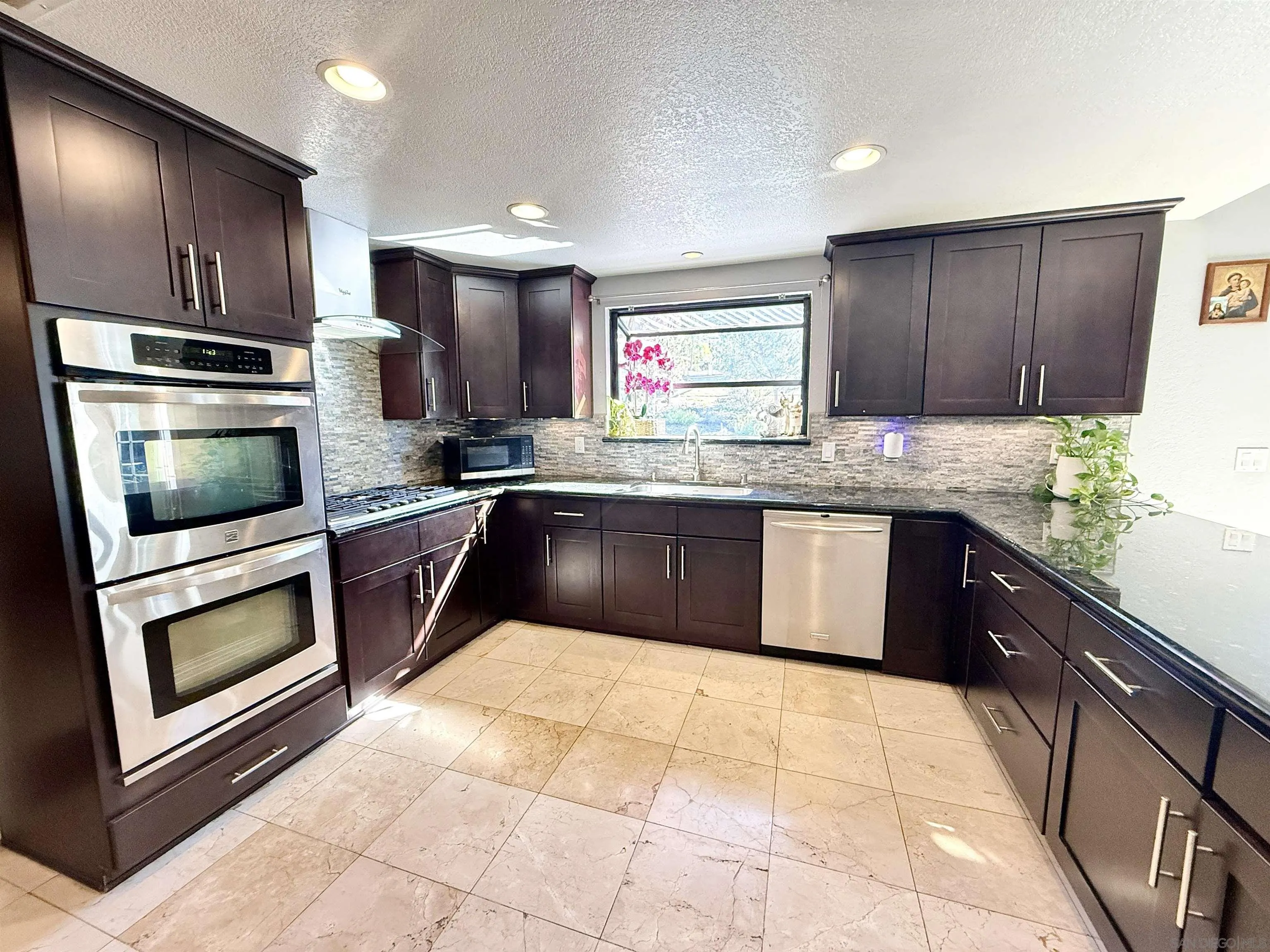 1423 Vista Grande Road El Cajon, CA 92019 - Photo 7 of 25 a kitchen with stainless steel appliances granite countertop a sink stove and oven