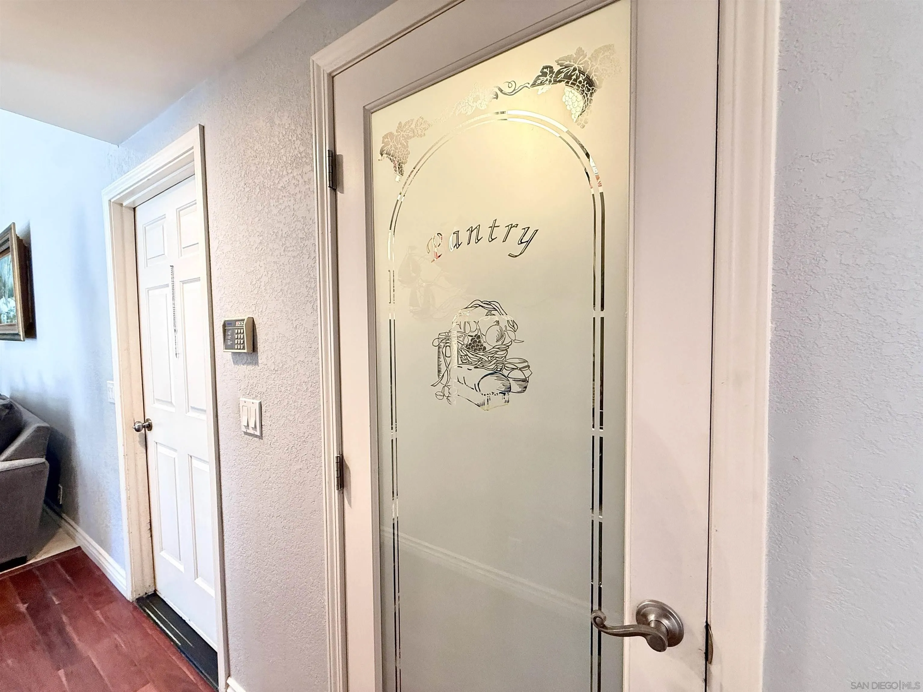 1423 Vista Grande Road El Cajon, CA 92019 - Photo 8 of 25 a view of a hallway with wooden floor and a bathroom