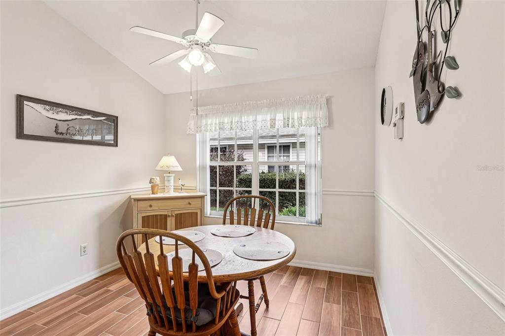 239 Juniper Way Tavares, FL 32778 - Photo 19 of 45 a view of a dining room with furniture window and wooden floor