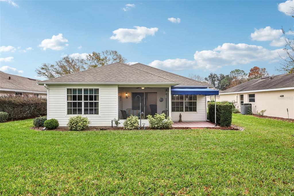 239 Juniper Way Tavares, FL 32778 - Photo 27 of 45 a front view of a house with a garden and porch