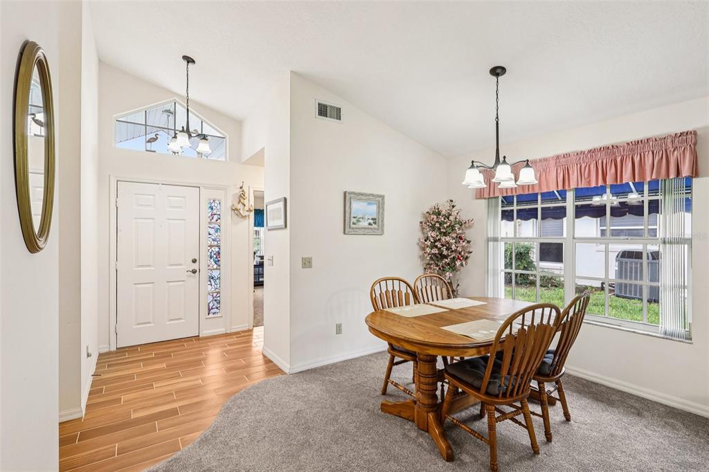 239 Juniper Way Tavares, FL 32778 - Photo 4 of 45 a view of a dining room with furniture window and wooden floor
