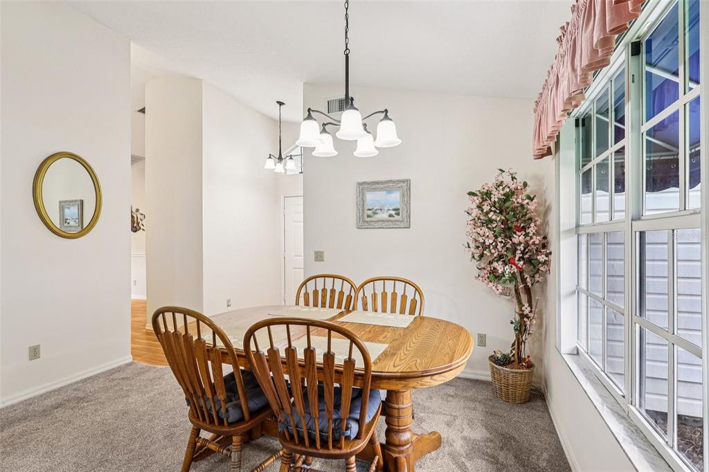 239 Juniper Way Tavares, FL 32778 - Photo 5 of 45 a view of a dining room with furniture and a chandelier