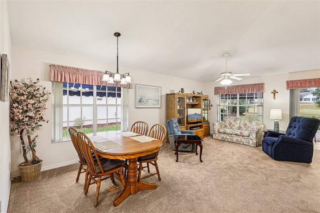239 Juniper Way Tavares, FL 32778 - Photo 7 of 45 a view of a dining room with furniture window and outside view