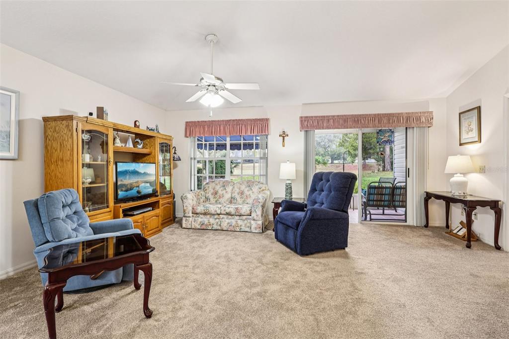 239 Juniper Way Tavares, FL 32778 - Photo 8 of 45 a living room with furniture and a flat screen tv