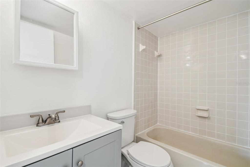 4208 Winding Moss Trail, Unit 102 Tampa, FL 33613 - Photo 19 of 27 a bathroom with a sink toilet and shower