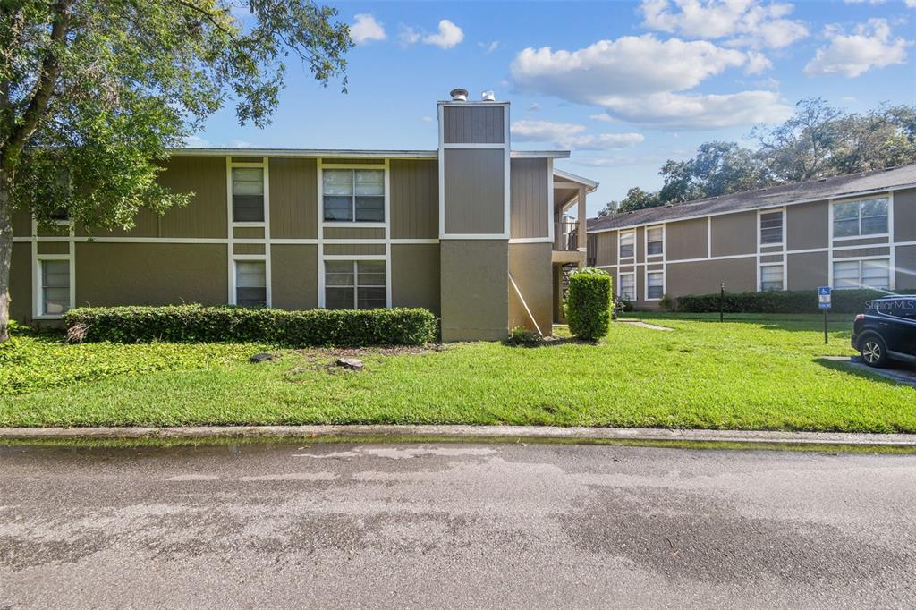 4208 Winding Moss Trail, Unit 102 Tampa, FL 33613 - Photo 5 of 27 a front view of a house with garden