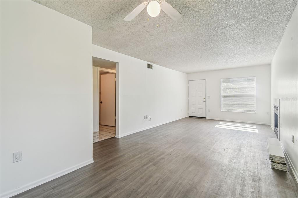 4208 Winding Moss Trail, Unit 102 Tampa, FL 33613 - Photo 8 of 27 wooden floor in an empty room