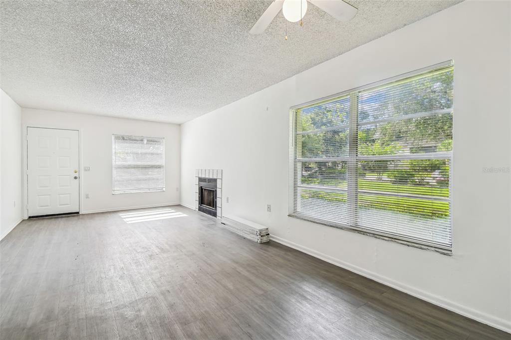 4208 Winding Moss Trail, Unit 102 Tampa, FL 33613 - Photo 9 of 27 an empty room with windows lake view and windows