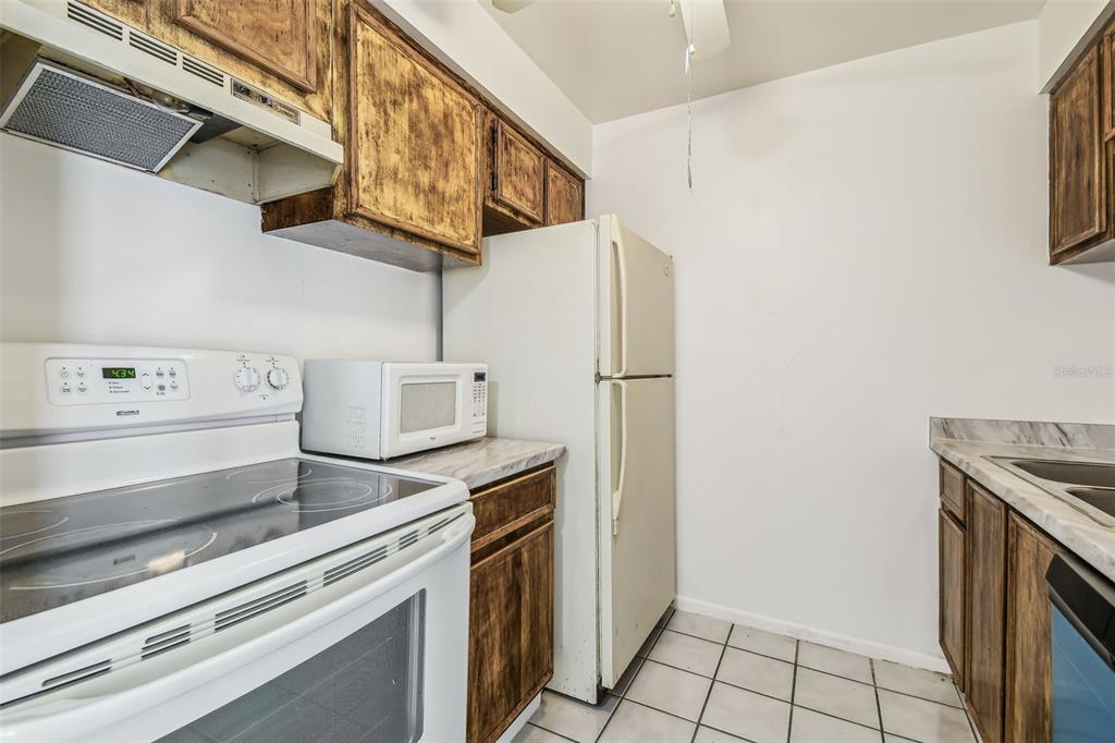 4208 Winding Moss Trail, Unit 102 Tampa, FL 33613 - Photo 10 of 27 a kitchen with stainless steel appliances cabinets and a counter