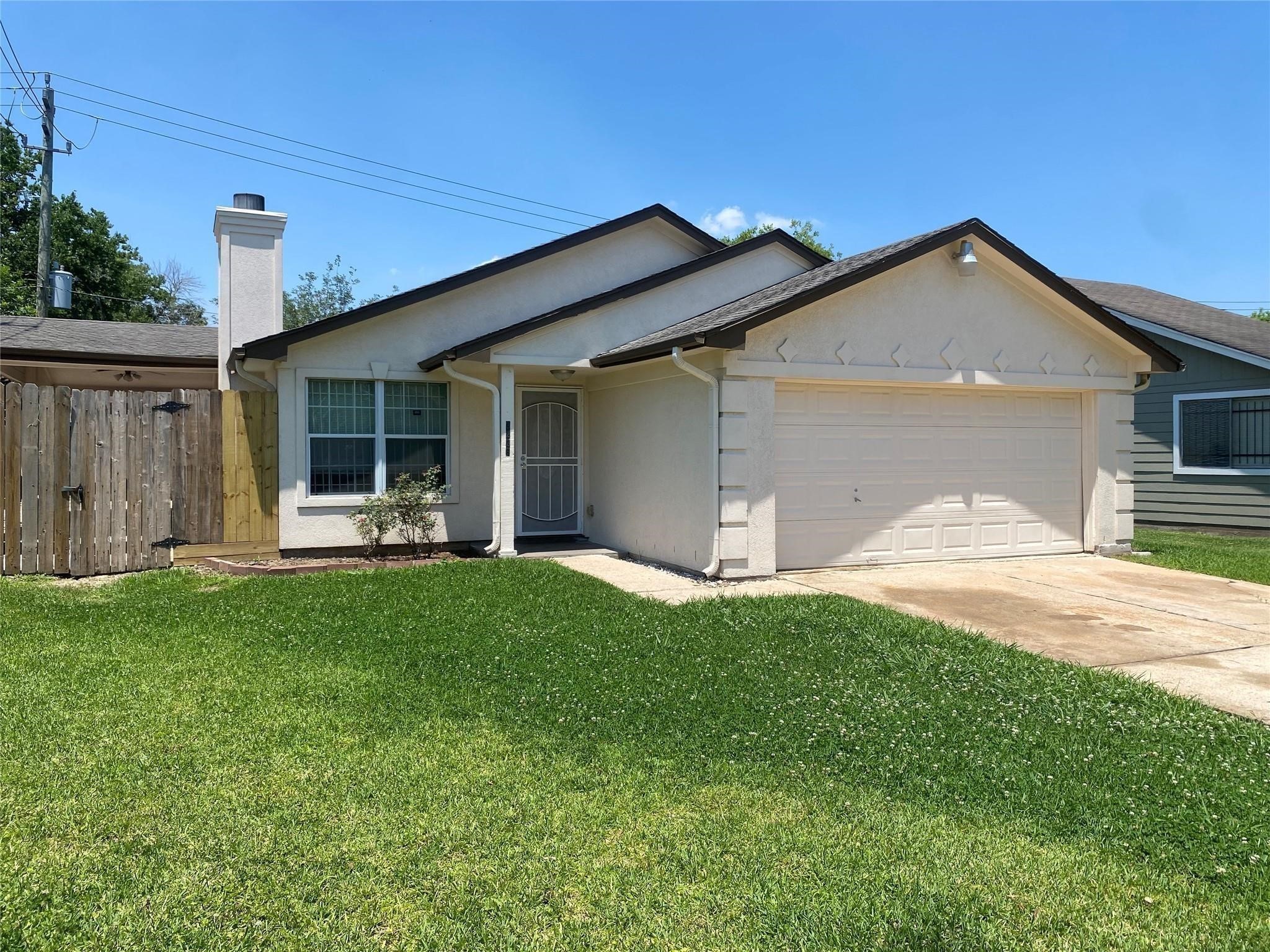 a front view of a house with a garden and yard
