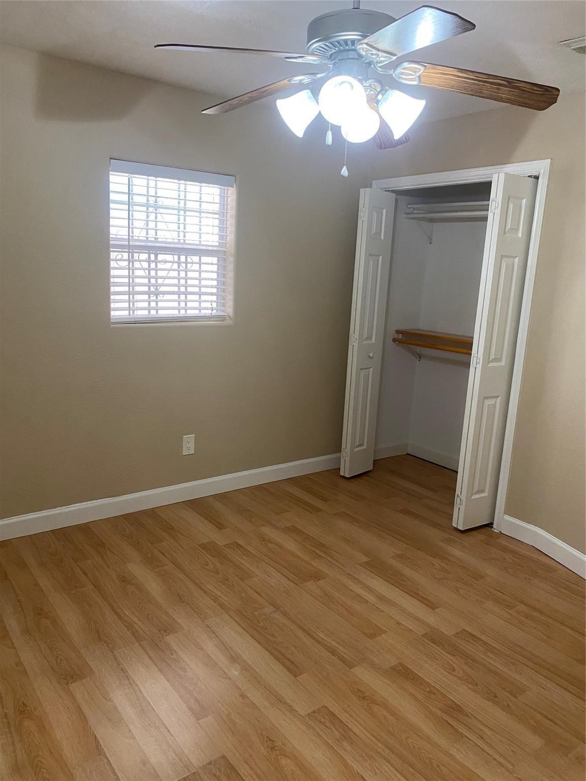 3226 Brookston Street Houston, TX 77045 - Photo 12 of 24 an empty room with wooden floor and windows