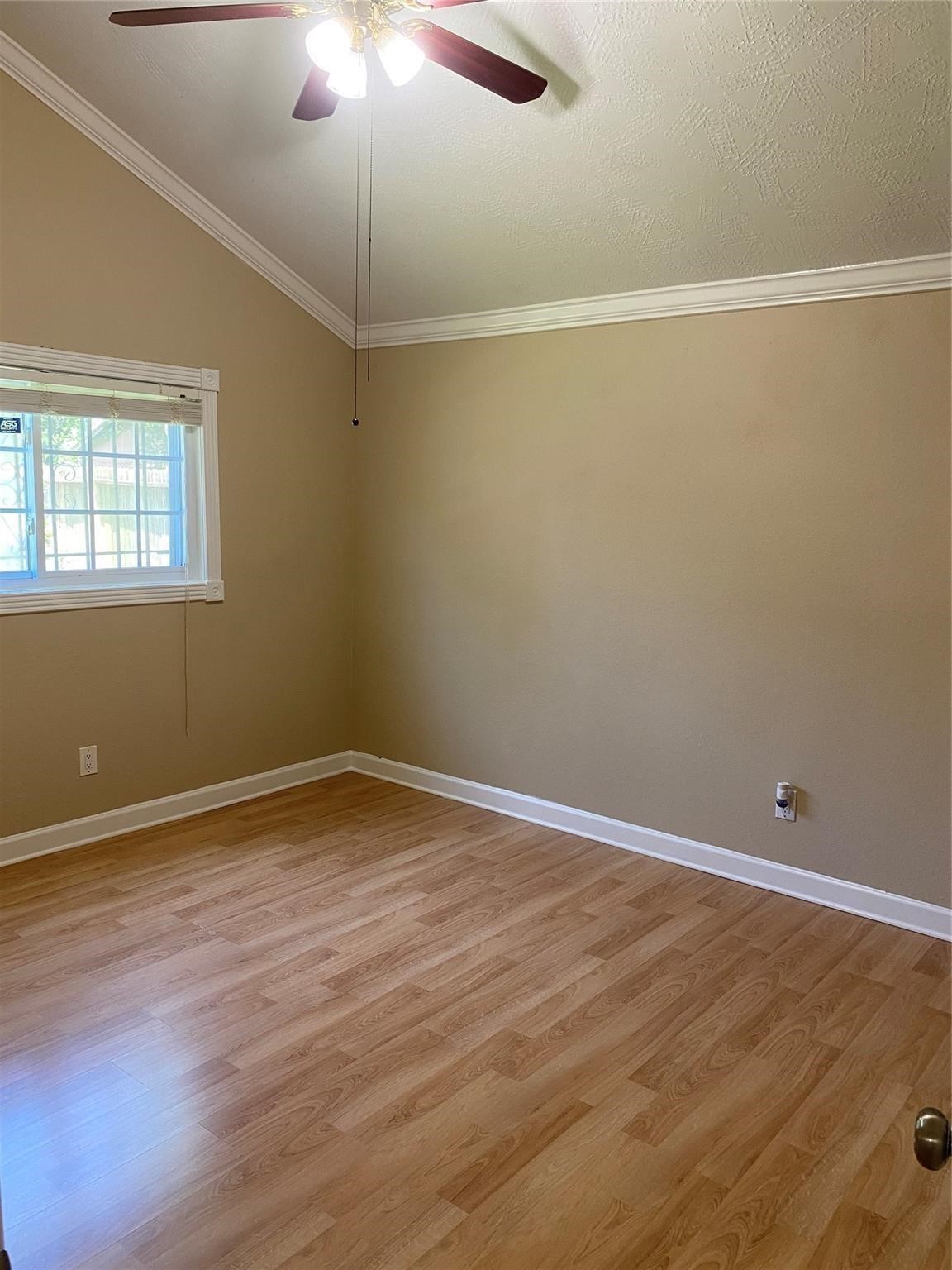 3226 Brookston Street Houston, TX 77045 - Photo 13 of 24 en empty room with wooden floor and fan