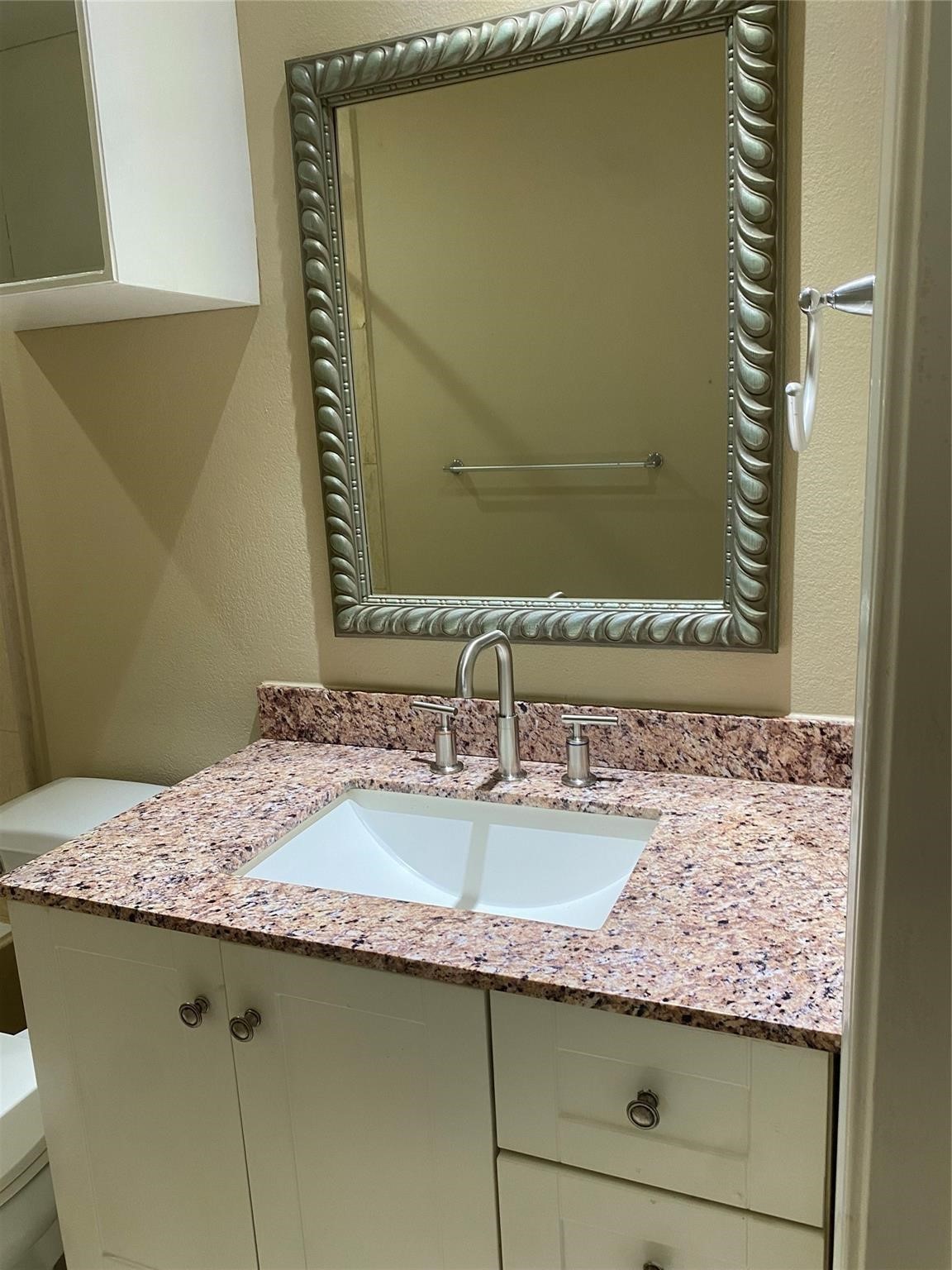 3226 Brookston Street Houston, TX 77045 - Photo 16 of 24 a bathroom with a granite countertop sink and a mirror