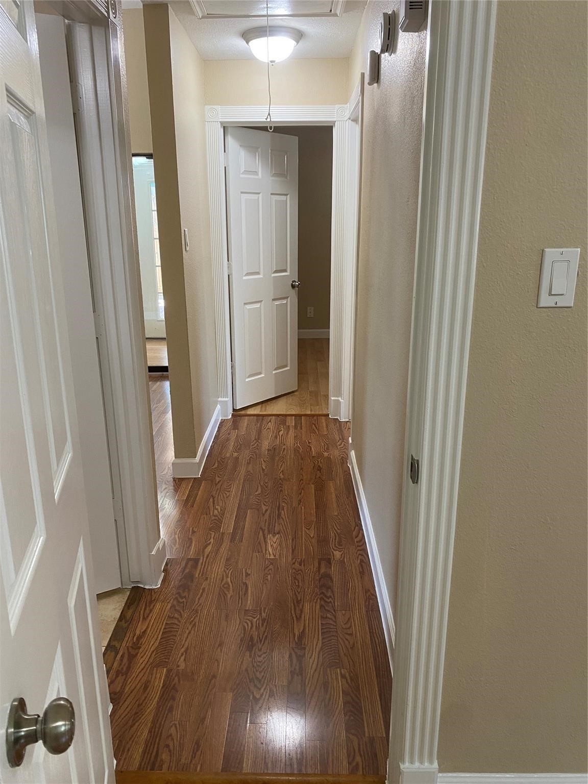 3226 Brookston Street Houston, TX 77045 - Photo 19 of 24 a view of a hallway with wooden floor