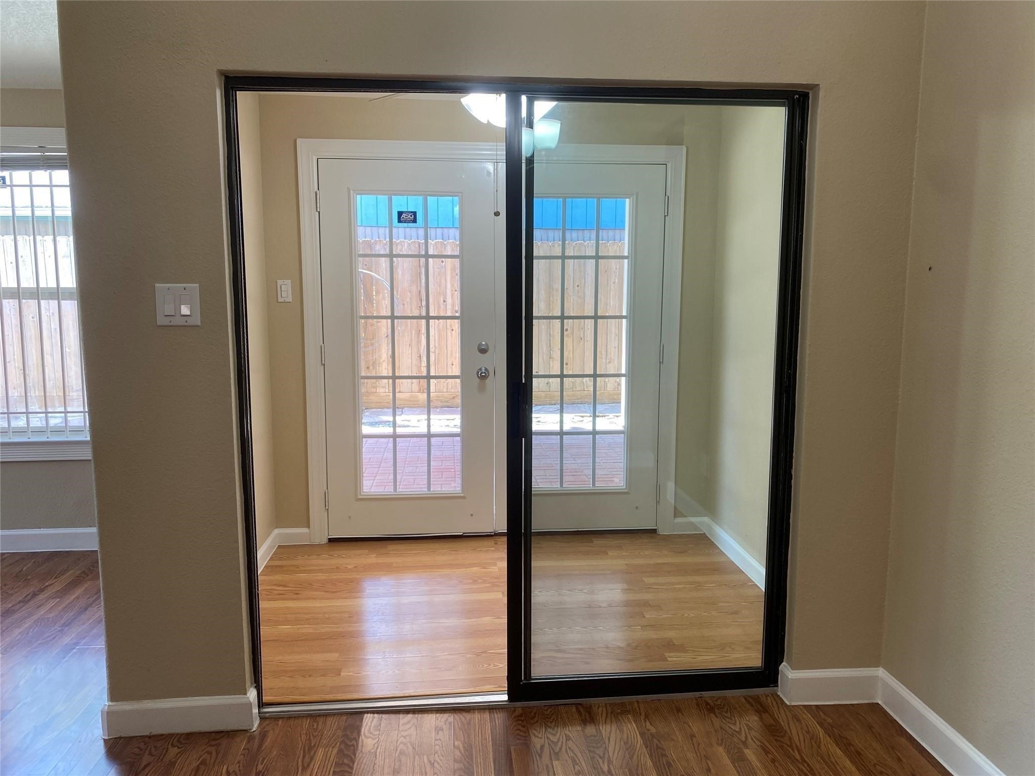 3226 Brookston Street Houston, TX 77045 - Photo 5 of 24 an empty room with wooden floor and windows