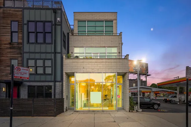 a view of a building with a floor to ceiling window and outdoor space
