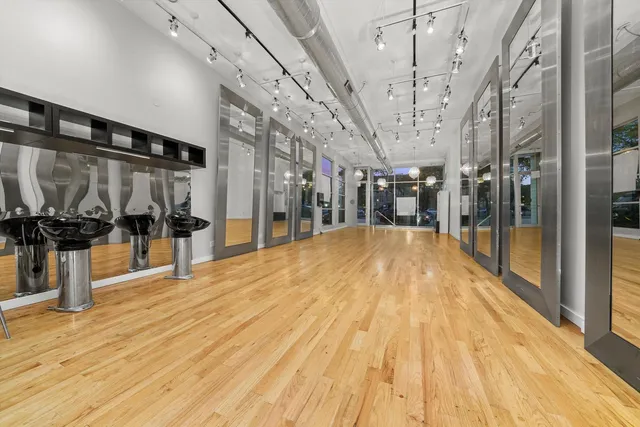 a bedroom with a bed and a dresser with the shoe rack