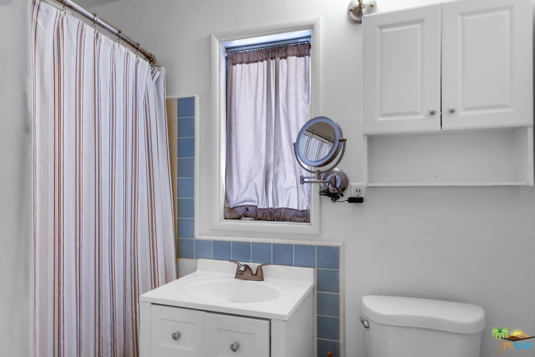71770 San Gorgonio Road Rancho Mirage, CA 92270 - Photo 40 of 45 a bathroom with a sink a toilet and a mirror