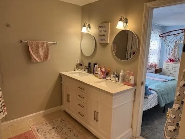 a bathroom with a sink mirror and vanity